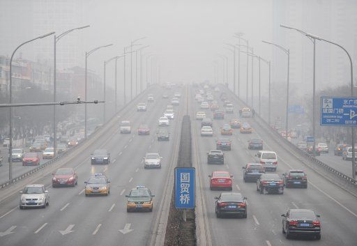 (140220) -- BEIJING, Feb. 20, 2014 (Xinhua) -- Vehicles run on smog-shrouded road in Beijing, capital of China, Feb. 20, 2014. Beijing on Thursday issued a yellow alert for air pollution in the next three days. The city has a four-tier alert system, ...