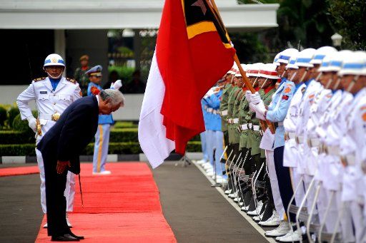 (140210) -- JAKARTA, Feb. 10, 2014 (Xinhua) -- Timor-Leste Defense Minister Kay Rala Xanana Gusmao (L, front) gives respect to the flags while inspects the troops during a welcoming ceremony in front of the Indonesian Defense Ministry in Jakarta, ...