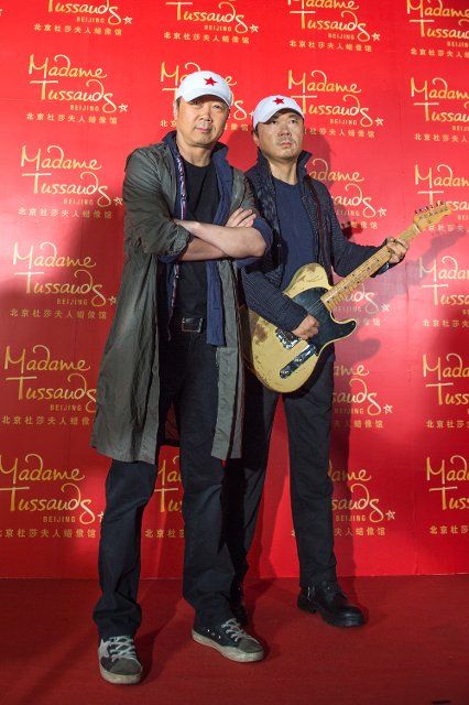 (140311) -- BEIJING, March 11, 2014 (Xinhua) -- Chinese rock star Cui Jian (L) poses with his wax figure during an activity held by the Madame Tussauds in Beijing, capital of China, March 11, 2014. The Madame Tussauds Beijing is expected to open in ...