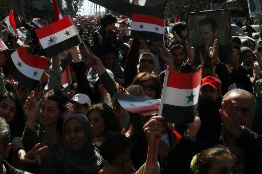 (140228) -- DAMASCUS, Feb. 28, 2014 (Xinhua) -- Supporters of Syrian President Bashar al-Assad wave Syrian national flags during a rally in Damascus, Syria, on Feb. 28, 2014. (Xinhua\/Bassem Tellawi)