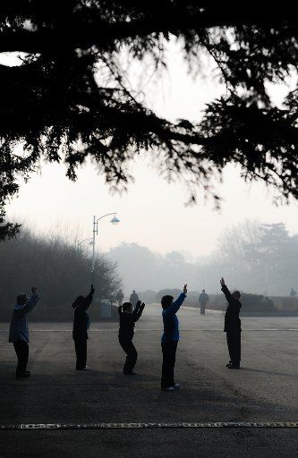 (140326) -- CHANGCHUN, March 26, 2014 (Xinhua) -- Residents do morning exercises amid fog and smog in Changchun, capital of northeast China\