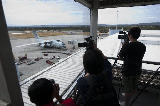 (140326) -- PERTH, March 26, 2014 (Xinhua) -- A Chinese Air Force plane returns to the International Airport of Perth in Perth, Australia, March 26, 2014. The search for debris of the missing Malaysia Airlines Flight MH370 in the southern Indian ...
