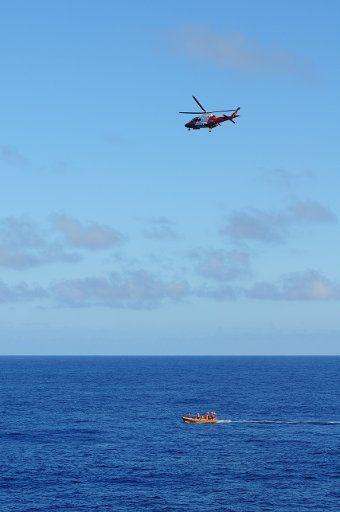 (140329) -- ABOARD HAIXUN 01, March 29, 2014 (Xinhua) -- A boat and a helicopter of Chinese Maritime Safety Administration patrol ship Haixun 01 search for the missing Malaysia Airlines flight MH370 in the southern Indian Ocean, March 29, 2014. ...