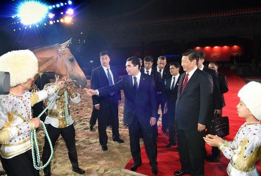 (140512) -- BEIJING, May 12, 2014 (Xinhua) -- Chinese President Xi Jinping (2nd R, front) receives an Akhal-Teke horse presented by his Turkmenistan counterpart Gurbanguly Berdymukhamedov (3rd R, front) during the opening ceremony of the ...