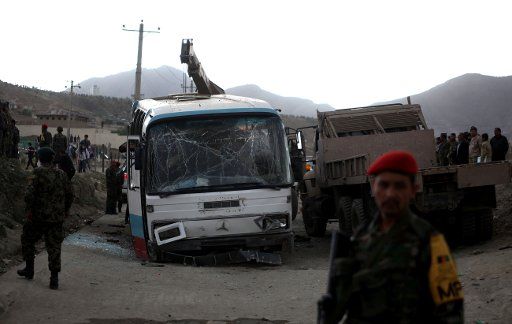 (140526) -- KABUL, May 26, 2014 (Xinhua) -- Afghan security forces inspect the site of suicide bombing in Kabul, Afghanistan, May 26, 2014. A suicide bomber targeted a bus of Afghan national army personnel in capital city Kabul on Monday, killing at ...