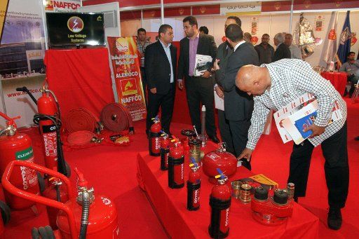 (140518) -- TRIPOLI, May 18, 2014 (Xinhua) -- Customers ask prices of firefighting equipments during the International Exhibition of Security and Safety in Tripoli, Libya, May 18, 2014. The International Exhibition of Security and Safety held here ...