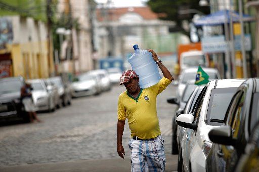 (140623) -- RECIFE, June 23, 2014 (Xinhua) -- A worker carries a water container in the city of Recife, in Brazil, on June 23, 2014. (Xinhua\/Mauricio Valenzuela) (rh)