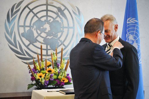 (140707) -- NEW YORK, July 7, 2014 (Xinhua) -- Peter Thomas Drennan (R), UN Under-Secretary-General for the Department of Safety and Security, has a pin attached by UN Secretary-General Ban Ki-moon, during a swearing-in ceremony held at the UN ...