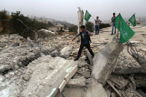(140818) -- HEBRON, Aug. 18, 2014 (Xinhua) -- Palestinian boys stand on the rubble of the house of Hussam Kawasme, a Palestinian who Israel suspects of the abduction and killing of three Israeli teenagers in June, after it was demolished by Israeli ...