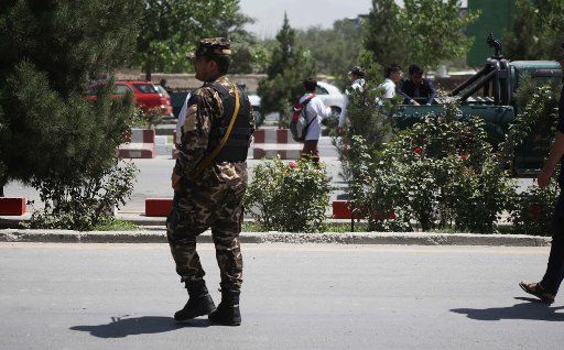 (140820) -- KABUL, Aug. 20, 2014 (Xinhua) -- An Afghan soldier walks at the site of an attack in Kabul, Afghanistan, Aug. 20, 2014. Unidentified armed men attacked a foreigner with knife on the road leading to Kabul airport and injured him on ...