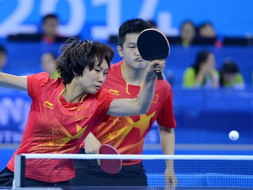 (140821) -- NANJING, Aug. 21, 2014 (Xinhua) -- Liu Gaoyang(L) and Fan Zhendong of China compete in the mixed international team first stage group A of table tennis event during Nanjing 2014 Youth Olympic Games in Nanjing, capital of east China?s ...