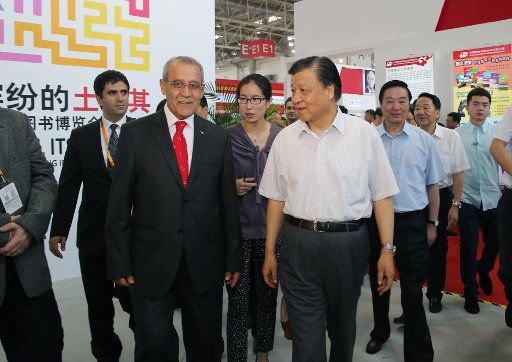 (140831) -- BEIJING, Aug. 31, 2014 (Xinhua) -- Liu Yunshan (R front), a Standing Committee member of the Communist Party of China Central Committee Political Bureau, arrives at the Turkish pavilion while visiting the Beijing International Book Fair ...