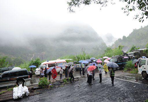 (140901) -- CHONGQING, Sept. 1, 2014 (Xinhua) -- Rescuers discuss rescue plans after a rain-triggered landslide hit Yongfa coal mine in Jiangkou Township, Yunyang County in southwest China\