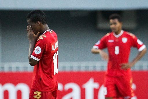 (141010) -- NAY PYI TAW, Oct. 10, 2014 (Xinhua) -- Al-Mandhar Rabia Said Al Alawi (L) of Oman reacts during a Group D match against Iraq at the AFC U-19 Championship in Nay Pyi Taw, Myanmar, Oct. 10, 2014. Oman lost 0-6. (Xinhua\/Zheng Huansong)