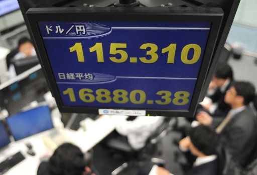 (141107) -- TOKYO, Nov. 7, 2014 (Xinhua) -- An electronic board shows the rate of yen againt dollar and Nikkei Stock average at a foreign exchange company in Tokyo, Japan, Nov. 7, 2014. Tokyo shares ended higher on Friday on hopes for further ...