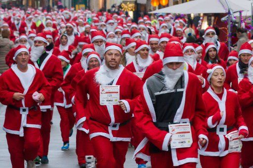 (141206) -- BUDAPEST, Dec. 6, 2014 (Xinhua) -- People dressed in Santa Claus costumes participate in the first Santa Run in Budapest, Hungary, on Dec. 6, 2014.(Xinhua\/Attila Volgyi)