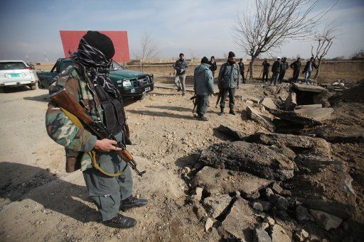 (141213) -- PARWAN, Dec. 13, 2014 (Xinhua) -- Afghan policemen keep watch at the site of a blast in Parwan province, Afganistan, Dec. 13, 2014. A bomb attack targeted a NATO forces\