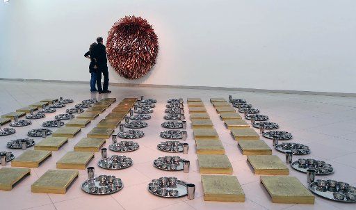 (141120) -- FRANKFURT, Nov. 20, 2014 (Xinhua) -- Visitors admire art works at the exhibition "Everything is Inside" of the Indian artist Subodh Gupta at the Museum for Modern Art in Frankfurt, Germany, on Nov. 19, 2014. The exhibition held from Sept....