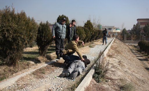 (141125) -- KABUL, Nov. 25, 2014 (Xinhua) -- Afghan security officers try to handcuff a suspected man fallowing a blast in Kabul, Afghanistan, Nov. 25, 2014. A big blast rocked the Afghan capital of Kabul on Tuesday but caused no casualties, police ...
