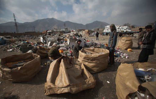 (150204) -- KABUL, Feb. 4, 2015 (Xinhua) -- Afghan men sort plastic and metal items collected from the rubbish dumps in Kabul, Afghanistan, Feb. 4, 2015. (Xinhua\/Ahmad Massoud)