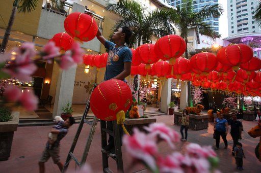 (150216) -- QUEZON CITY, Feb. 16, 2015 (Xinhua) -- A worker hangs Chinese lanterns at a park in Quezon City, the Philippines, Feb. 15, 2015. The Chinese Lunar New Year will be celebrated on Feb. 19. (Xinhua\/Rouelle Umali) (lyi)
