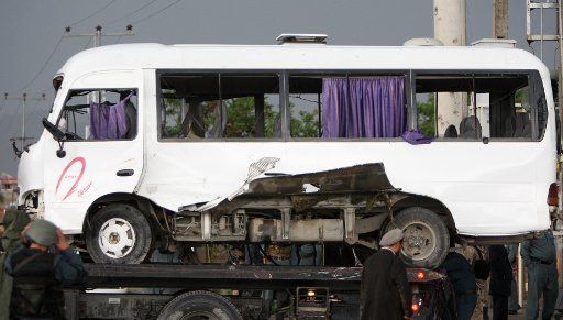 (150510) -- KABUL, May 10, 2015 (Xinhua) -- A truck transfers a damaged bus following a suicide bombing attack in Kabul, Afghanistan, on May 10, 2015. 3 people were killed and 16 others wounded as a suicide bomber attacked the bus of the Attorney ...