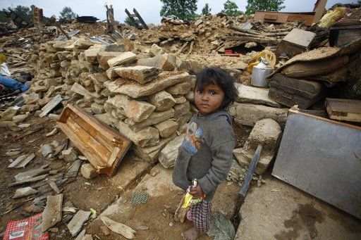 (150429) -- SINDHUPALCHOWK, April 29, 2015 (Xinhua) -- A girl collects materials at a destructed house after earthquake at Sindhupalchowk district, Nepal, April 29, 2015. By noon on Wednesday, more than 1,376 people had already been confirmed dead ...