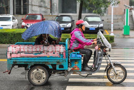 (150827) -- HUICHUN, Aug. 27, 2015 (Xinhua) -- A rider drives against the rain brought by Typhoon Goni in Huichun City, northeast China\