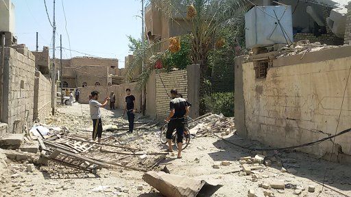 (150813) -- FALLOUJA, Aug. 13, 2015 (Xinhua) --People gather around a destroyed building after an airstrike by the Iraqi Air Force in Islamic State (IS) militants-seized city of Fallouja, some 50 kilometers west of Baghdad, Iraq, Aug. 13, 2015. At ...