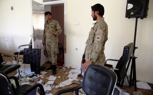 (151010) -- KUNDUZ, Oct. 10, 2015 (Xinhua) -- Policemen are seen at a destroyed room of a government building after Taliban militants burnt it down in Kunduz city, Afghanistan, Oct. 9, 2015. Fierce clashes erupted between the security forces and ...