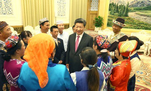 (150930) -- BEIJING, Sept. 30, 2015 (Xinhua) -- Chinese President Xi Jinping (C) meets with 13 outstanding grass-roots ethnic solidarity representatives at the Great Hall of the People in Beijing, capital of China, Sept. 30, 2015. On the 66th ...