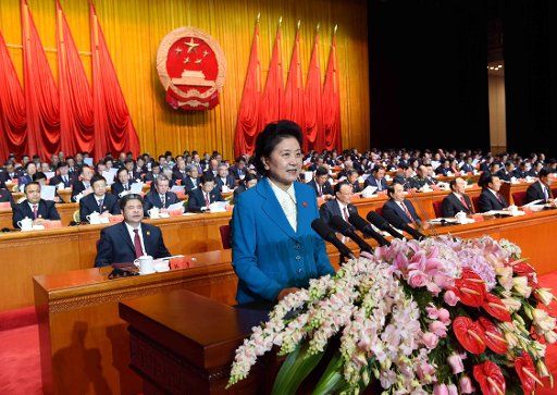 (151001) -- URUMQI, Oct. 1, 2015 (Xinhua) -- Chinese Vice Premier Liu Yandong (front) reads a congratulatory message from the central government at a grand rally marking the 60th anniversary of the founding of Xinjiang Uygur Autonomous Region in ...