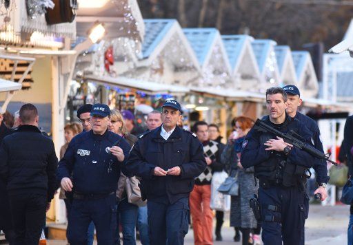 (151119) -- PARIS, Nov. 19, 2015 (Xinhua) -- Policemen patrol near the Christmas market of the Champs-Elysees Avenue in Paris, capital of France, on Nov. 18, 2015. The Christmas market of the Champs-Elysees Avenue reopened with poor business on ...