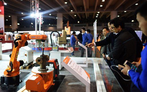 (151205) -- GUANGZHOU, Dec. 5, 2015 (Xinhua) -- Visitor view the exhibits during the China (Guangzhou) Intelligent Equipment and Robot Expo in Guangzhou, capital of south China\