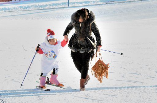 (160117) -- ZHALANTUN, Jan. 17, 2016 (Xinhua) -- A young girl is helped to take part in ski sports to greet the world snow day and international children skiing festival in Zhalantun City, north China\