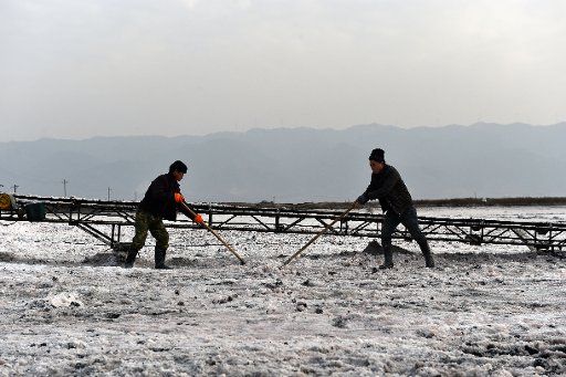 (160120) -- YUNCHENG, Jan. 20, 2016 (Xinhua) -- Workers harvest raw sodium sulfate at a salt lake in Yuncheng, north China\