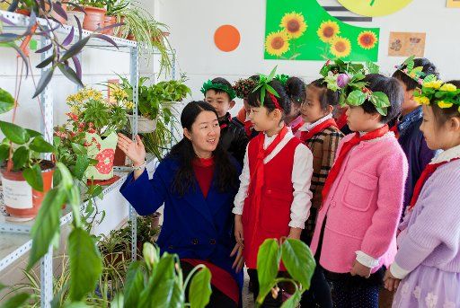 (160301) -- HOHHOT, March 1, 2016 (Xinhua) --Teacher Hao Jia (1st L) introduces plants to pupils at a primary school in Hohhot, capital of north China\