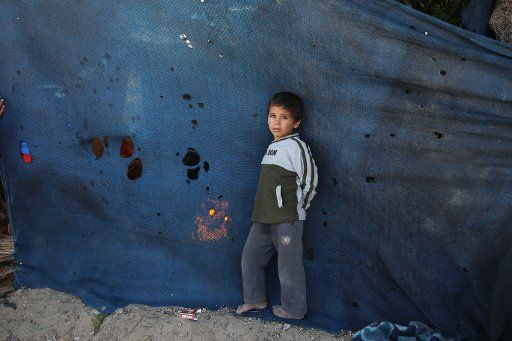 (160330) -- GAZA, March 30, 2016 (Xinhua) -- A Palestinian boy plays outside his makeshift house in the southern Gaza Strip city of Khan Younis, on March 30, 2016. Representatives from the National Corporation to Defeat the Siege Gaza stated during ...