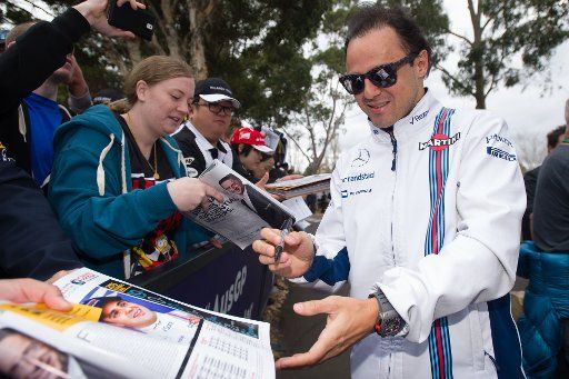 (160319) -- MELBOURNE, March 19, 2016 (Xinhua) -- Williams Martini Racing Formula One driver Felipe Massa(R) of Brazil autographs for fans before the third practice session ahead of the Australian Formula One Grand Prix in Melbourne, Australia, ...