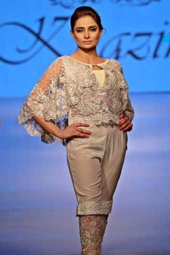 (160430) -- ISLAMABAD, April 30, 2016 (Xinhua) -- A model presents a creation by designer Zahid Khan during a fashion show at a local hotel in Islamabad, capital of Pakistan on April 30, 2016. Models present latest summer collection during the ...