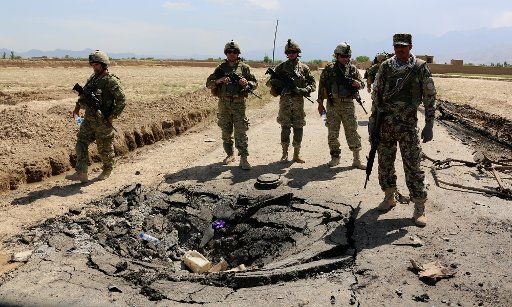(160521) -- KABUL, May 21, 2016 (Xinhua) -- NATO-led Resolute Support soldiers inspect the site of a suicide attack in Bagram district of Parwan province, Afghanistan, May 21, 2016. A suicide car bombing hit a foreign forces\