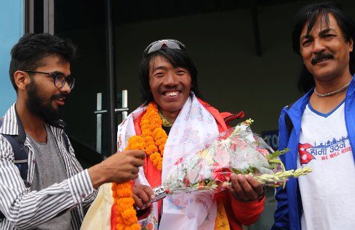 (160524) -- KATHMANDU, May 24, 2016 (Xinhua) -- Phurba Tenjing Sherpa (C), who successfully climbed Mount Qomolangma for 10 times, is welcomed after returning from Mount Qomolangma at the airport in Kathmandu, Nepal, May 24, 2016. (Xinhua\/Sunil ...