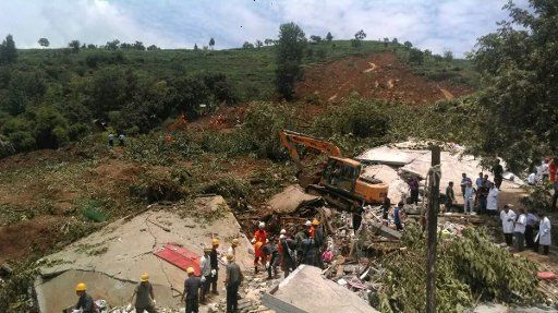 (160701) -- DAFANG, July 1, 2016 (Xinhua) -- Rescuers work at the accident site after a rain-triggered landslide hit Pianpo Village, Dafang County in the city of Bijie, southwest China\