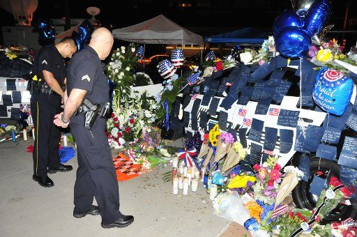 (160710) -- DALLAS, July 10, 2016 (Xinhua) -- Two police officers mourn for killed colleagues outside Dallas police headquarters in Dallas, the United States, on July 9, 2016. Five police officers were killed and seven others wounded Thursday by a ...