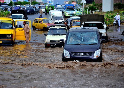 (160615) -- PESHAWAR, June 15, 2016 (Xinhua) -- Vehicles move into flooded water after heavy rain in northwest Pakistan\