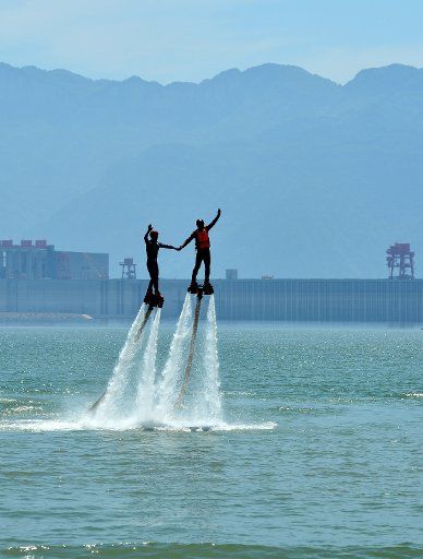 (160618) -- YICHANG, June 18, 2016 (Xinhua) -- Members of motorboat acrobatic team perform acrobatics in the water in front of the Three Gorges Dam in Yichang, central China\