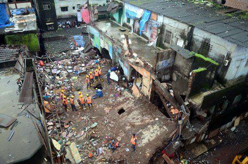 (160801) -- MUMBAI, Aug. 1, 2016 (Xinhua) -- Rescue workers stand at the building collapse site in Bhiwandi, near Mumbai, India, July 31, 2016. At least nine people have been killed and 10 others injured after a two-storeyed building collapsed near ...