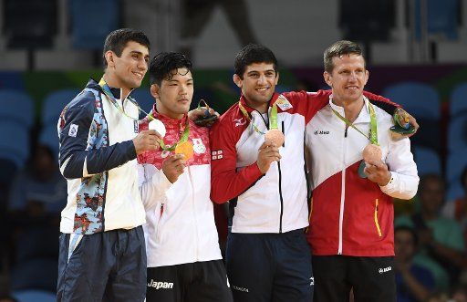 (160808) -- RIO DE JANEIRO, Aug. 8, 2016 (Xinhua) -- Gold medalist Shohei Ono of Japan (2nd, L), silver medalist Rustam Orujov of Azerbaijan (1st, L), bronze medalists Lasha Shavdatuashvili of Georgia (2nd, R) and Dirk Van Tichelt of Belgium pose ...