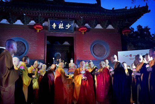 (160814) -- ZHENGZHOU, Aug. 14, 2016 (Xinhua) -- Shaolin Abbot Shi Yongxin (C) and monks carrying lotus-pattern lamps attend a buddhist ritual at the Shaolin Temple on the Songshan Mountain in Dengfeng City, central China\