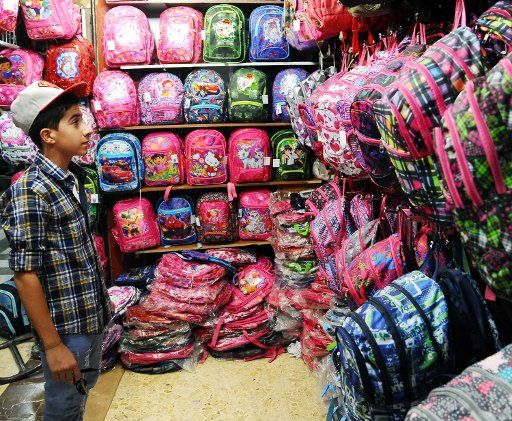 (160917) -- DAMASCUS, Sept. 17, 2016 (Xinhua) -- A Syrian boy watches new school bags at a marketplace in Damascus, capital of Syria, on Sept. 17, 2016. Schoolchildren are bracing from the new academic year in Syria, which is due to begin on Sunday. ...